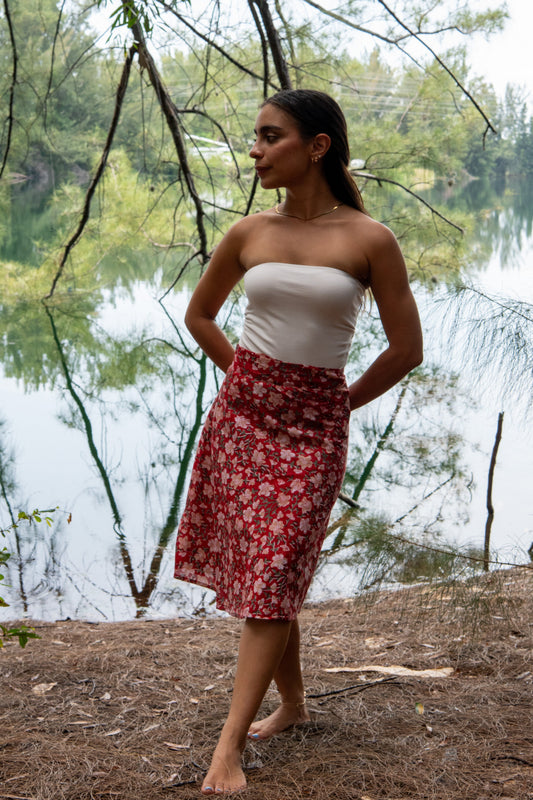 woman wearing a red floral  printed midi skirt 