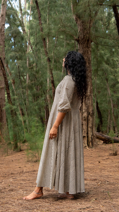 Woman in a long dress standing in a forest