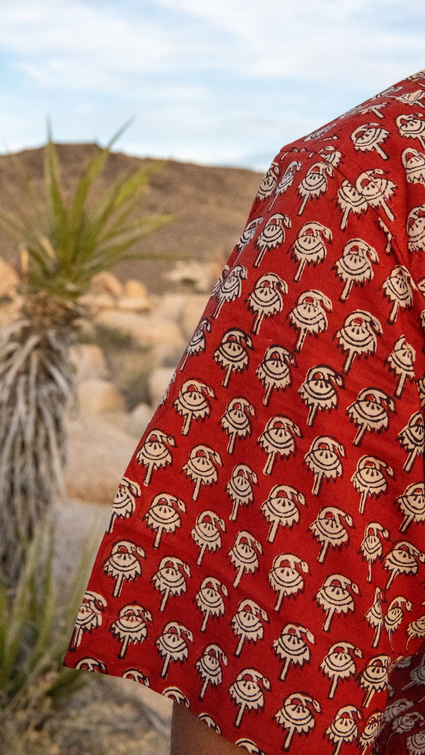 Red fabric with white patterns in a desert setting