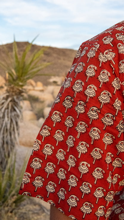 Red fabric with white patterns in a desert setting