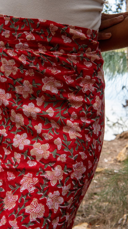 Red floral skirt with a blurred natural background